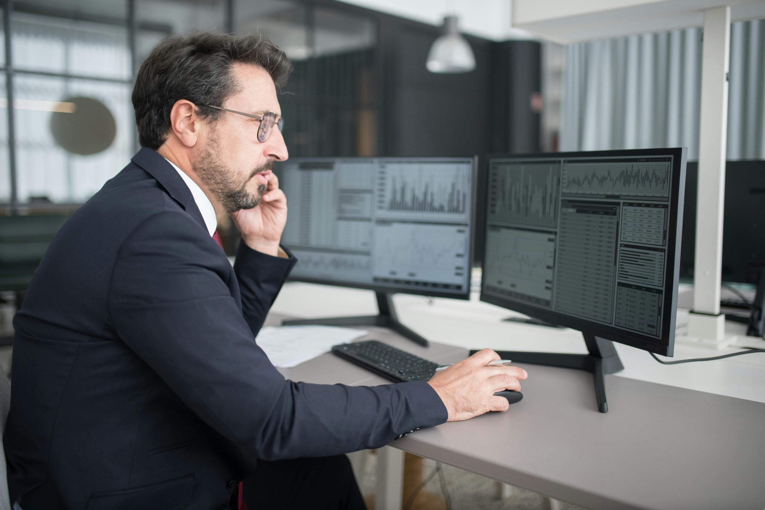 Man analyzing data on a double monitor set up