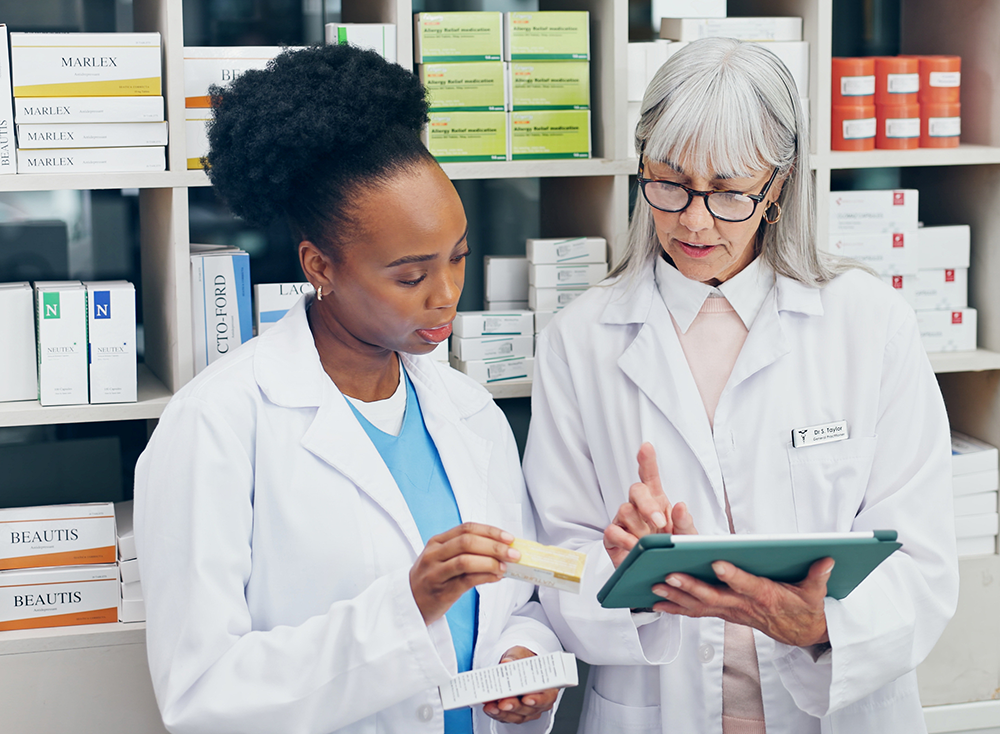 Chemist and pharmacy staff in conversation