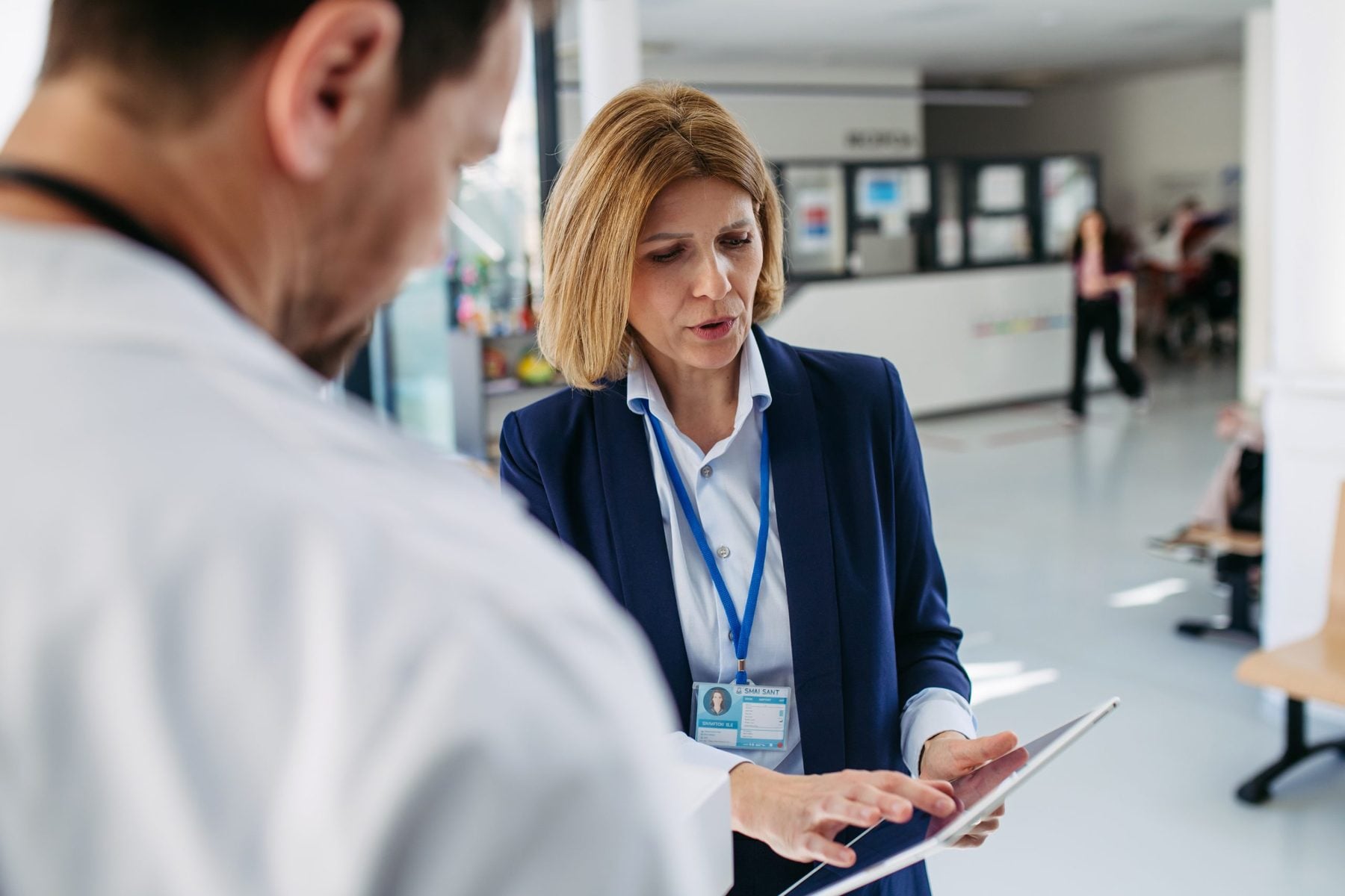 Field representative checking an HCP record on a tablet