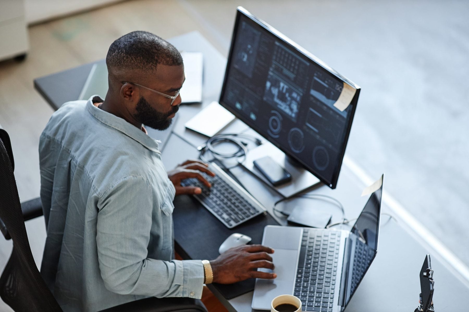 Credentialing analyst verifying licenses at a workstation