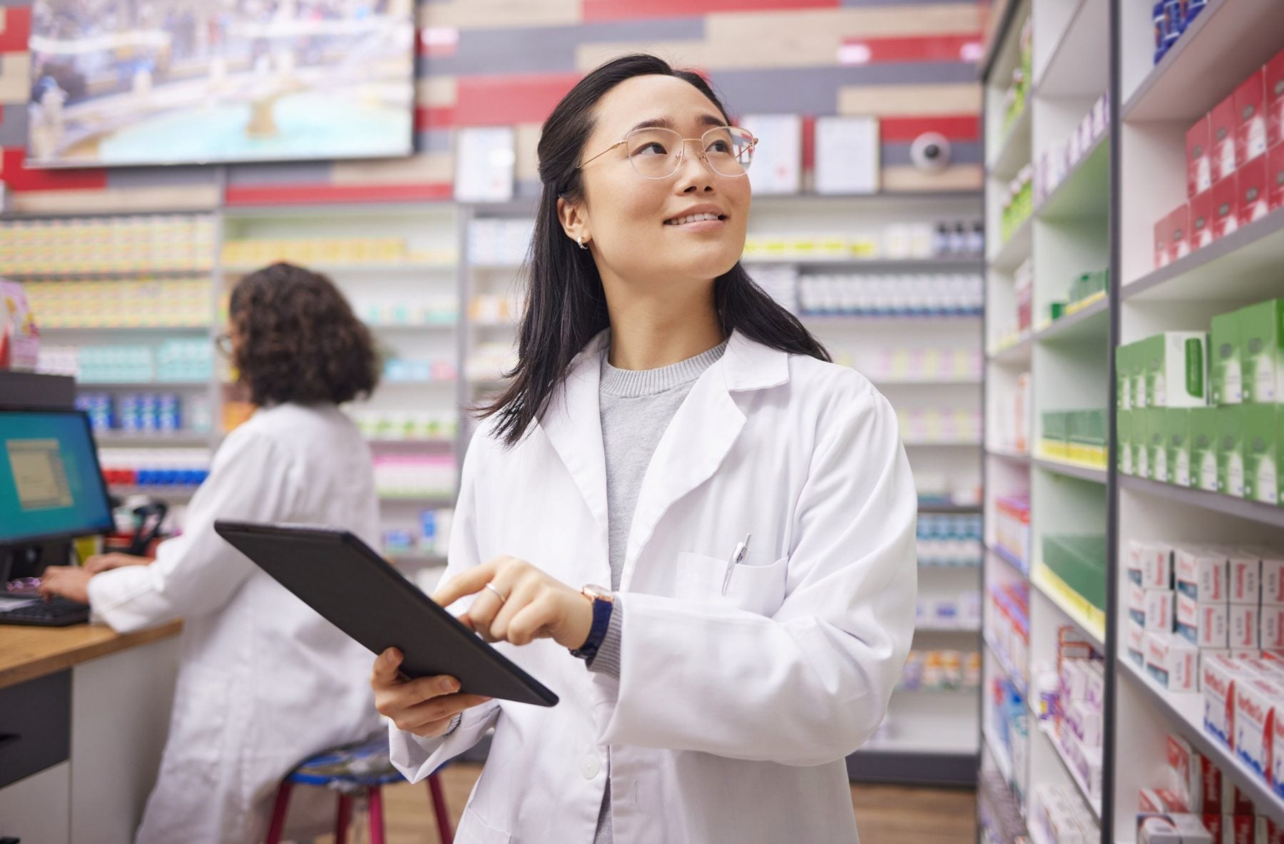 Pharmacist checking a prescriber record on a tablet