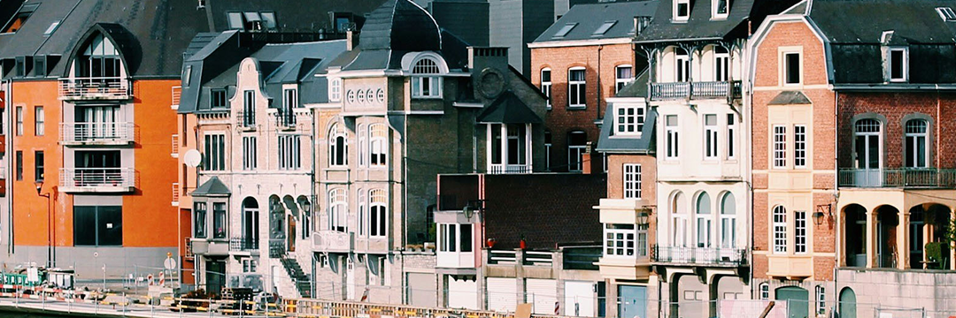 Row of ornate townhouses along a street in Belgium