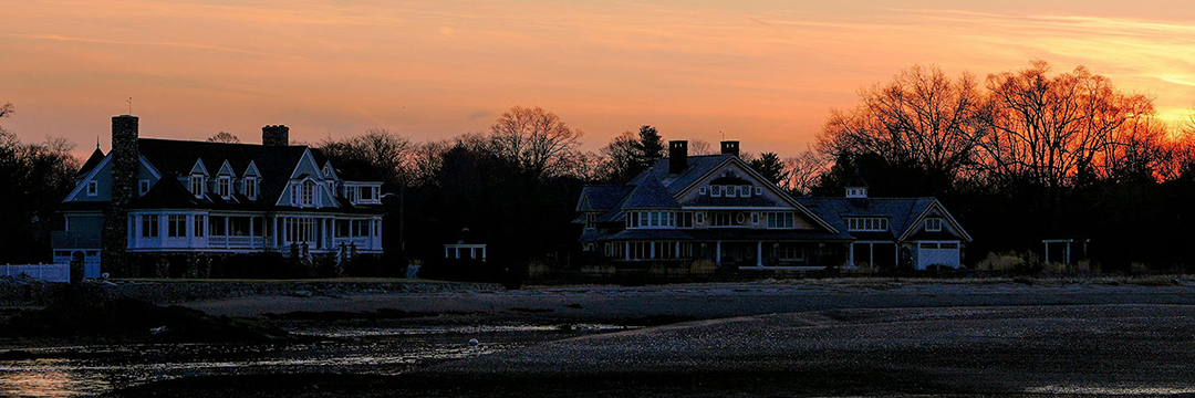 Shingle-style homes on the Connecticut shoreline at sunset