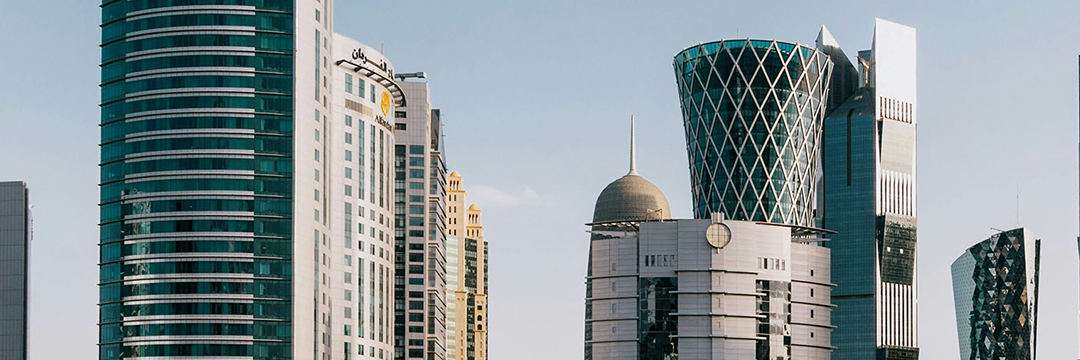 Modern glass towers on a Middle Eastern city skyline