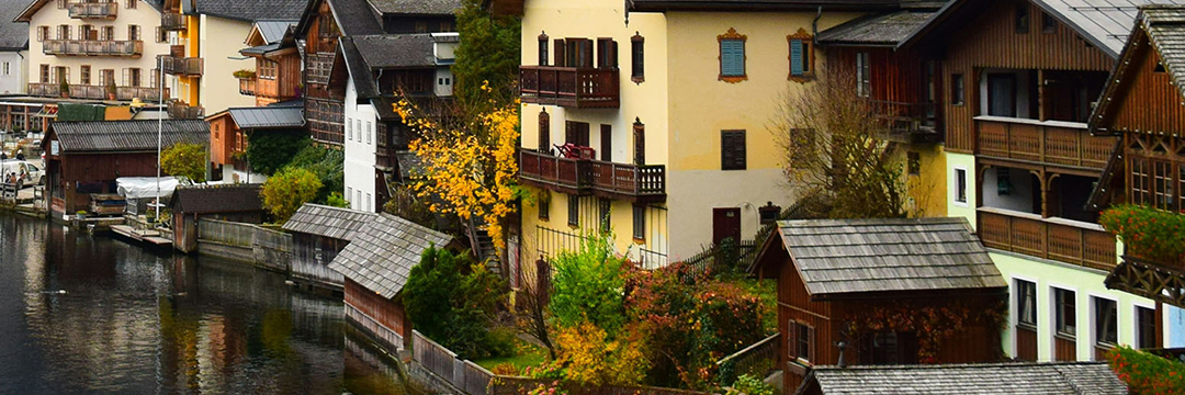 Wooden houses along a lake in a European alpine village