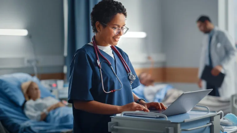 Nurse reviewing a provider record on a laptop