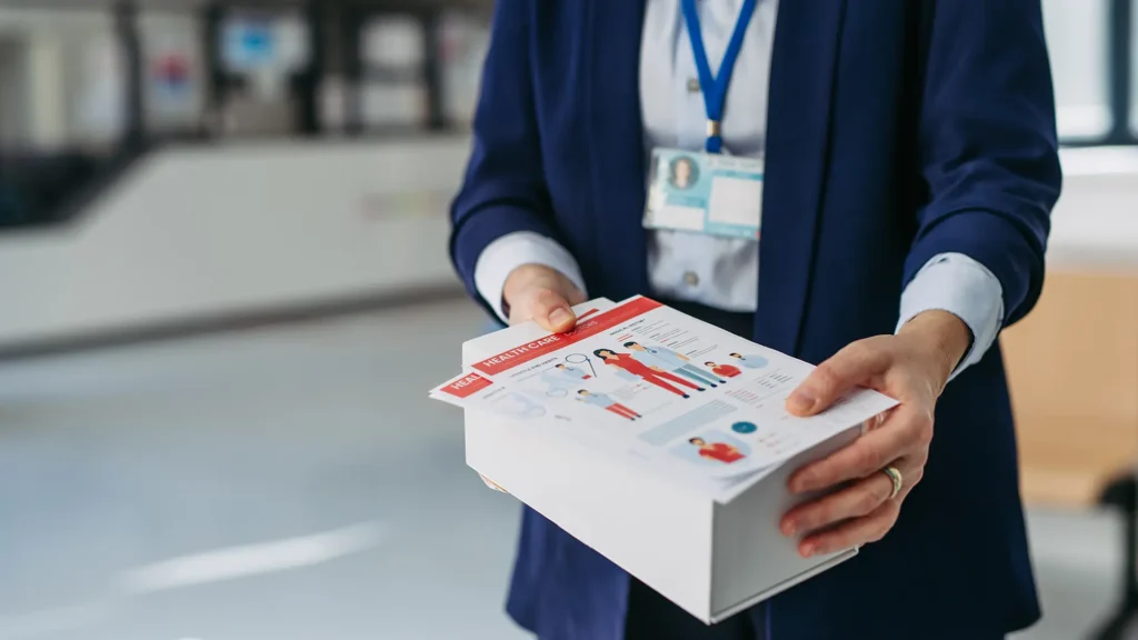 Representative holding a drug sample box and leaflet