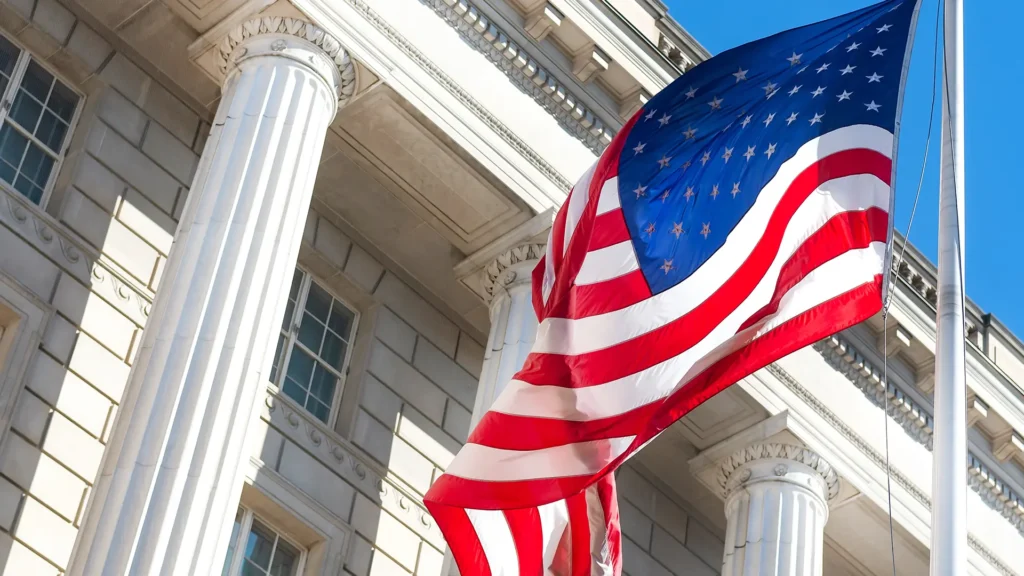 U.S. flag flying outside a columned government building